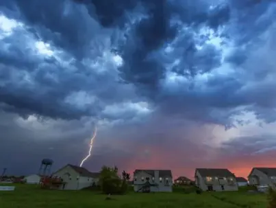 A dramatic lightning strike illuminates dark storm clouds